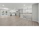 Bright living space featuring a white kitchen, hardwood floors, chandelier, and a staircase with wooden railings at 1277 Muirforest Dr, Stone Mountain, GA 30088
