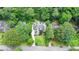 Aerial view of a luxury home surrounded by lush greenery, mature trees, and manicured lawns at 272 Lake Forrest Ne Ln, Atlanta, GA 30342