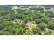 Aerial view of a luxury home surrounded by mature trees, near golf and country club at 272 Lake Forrest Ne Ln, Atlanta, GA 30342
