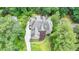Aerial view of a luxury home surrounded by lush greenery and mature trees at 272 Lake Forrest Ne Ln, Atlanta, GA 30342