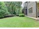Large, well-manicured backyard with lush green lawn and professional landscaping at 272 Lake Forrest Ne Ln, Atlanta, GA 30342