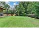 Expansive backyard featuring a playground, beautiful lawn, and manicured landscaping at 272 Lake Forrest Ne Ln, Atlanta, GA 30342