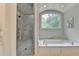Spa-like bathroom with a luxurious soaking tub, walk-in shower with glass door, and elegant finishes at 272 Lake Forrest Ne Ln, Atlanta, GA 30342