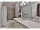 Bathroom with white vanity, granite countertop, a large mirror, and shower with neutral tile at 272 Lake Forrest Ne Ln, Atlanta, GA 30342