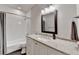 Stylish bathroom with a granite countertop, white cabinets, and tiled shower, combining elegance and functionality at 272 Lake Forrest Ne Ln, Atlanta, GA 30342