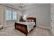 Cozy bedroom featuring a wooden bed frame, soft carpet, decorative pillows, and a stylish chandelier at 272 Lake Forrest Ne Ln, Atlanta, GA 30342