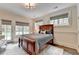 Comfortable bedroom with natural light, a plush bed, and view to backyard, creating a serene atmosphere at 272 Lake Forrest Ne Ln, Atlanta, GA 30342