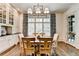 Cozy dining room with a wooden table, large window, and shutter-style blinds at 272 Lake Forrest Ne Ln, Atlanta, GA 30342
