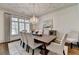Stylish dining room features a decorative ceiling, chandelier, a large window and hardwood floors at 272 Lake Forrest Ne Ln, Atlanta, GA 30342