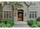 Close up of a luxurious brick home entrance featuring double doors and stone walkway at 272 Lake Forrest Ne Ln, Atlanta, GA 30342