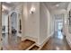 Elegant hallway featuring hardwood floors and detailed trim, leading to other rooms in the home at 272 Lake Forrest Ne Ln, Atlanta, GA 30342