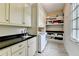 Well-organized laundry room with sink, modern machines, and ample storage space at 272 Lake Forrest Ne Ln, Atlanta, GA 30342