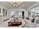 Open living area with built-in shelving, fireplace, and views into the kitchen and dining areas at 272 Lake Forrest Ne Ln, Atlanta, GA 30342