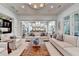 Bright and airy living room showcasing hardwood floors, a fireplace, and seamless access to the kitchen at 272 Lake Forrest Ne Ln, Atlanta, GA 30342