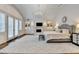 Luxurious main bedroom features a tray ceiling, fireplace, built-in shelving, and plush furnishings at 272 Lake Forrest Ne Ln, Atlanta, GA 30342