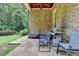 Outdoor kitchen featuring a grill, dining chairs, and stone floors on a covered patio at 272 Lake Forrest Ne Ln, Atlanta, GA 30342