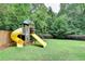 Backyard playground area with slide and swing set in a lush, green yard at 272 Lake Forrest Ne Ln, Atlanta, GA 30342