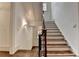 Elegant staircase features hardwood steps, white risers, and a decorative iron railing, bathed in natural light at 272 Lake Forrest Ne Ln, Atlanta, GA 30342