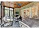 Spacious sunroom with brick accents, fireplace, wooden ceiling, and outdoor access offering tranquil views and natural light at 272 Lake Forrest Ne Ln, Atlanta, GA 30342