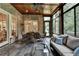 Cozy sunroom with tile flooring, comfortable seating, and large windows offering serene outdoor views and natural light at 272 Lake Forrest Ne Ln, Atlanta, GA 30342