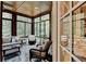 Bright and airy sunroom with wooden ceiling, floor-to-ceiling windows, and comfortable seating, connecting indoor with outdoor living at 272 Lake Forrest Ne Ln, Atlanta, GA 30342