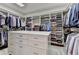 Spacious walk-in closet with custom shelving, drawers, and ample storage space for clothes and accessories at 272 Lake Forrest Ne Ln, Atlanta, GA 30342