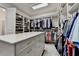 Well-organized walk-in closet with extensive shelving, drawers, and hanging space for clothing at 272 Lake Forrest Ne Ln, Atlanta, GA 30342