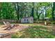 Spacious backyard with chairs, fire pit, shed, and playground set at 2985 Westbury Dr, Decatur, GA 30033