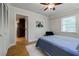 Bright bedroom featuring hardwood floors, a ceiling fan, and ample natural light from the window at 2985 Westbury Dr, Decatur, GA 30033
