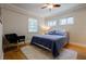 Cozy bedroom with hardwood floors, a ceiling fan, and a comfortable bed with blue linens at 2985 Westbury Dr, Decatur, GA 30033
