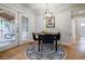 Bright breakfast nook with a round table, modern lighting, and access to a screened-in porch at 2985 Westbury Dr, Decatur, GA 30033