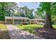 Inviting single-story home with a long driveway and lush green lawn in a tranquil setting at 2985 Westbury Dr, Decatur, GA 30033