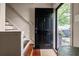 Inviting entryway showcasing a black front door, hardwood floors, and a glimpse of greenery at 136 Peachtree Memorial Nw Dr # Nh4, Atlanta, GA 30309