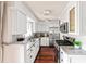 Updated kitchen with white cabinets, stainless steel appliances, and granite countertops at 136 Peachtree Memorial Nw Dr # Nh4, Atlanta, GA 30309