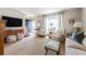 Bright living room featuring hardwood floors, bay window, and neutral decor at 136 Peachtree Memorial Nw Dr # Nh4, Atlanta, GA 30309