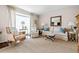 Cozy living room with neutral tones, plush seating, and bright natural light from large window at 136 Peachtree Memorial Nw Dr # Nh4, Atlanta, GA 30309