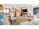 Open floor plan in living room with hardwood floors, neutral paint, and television at 136 Peachtree Memorial Nw Dr # Nh4, Atlanta, GA 30309