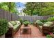 Cozy brick patio features comfortable seating and lush landscaping, creating a perfect outdoor retreat at 136 Peachtree Memorial Nw Dr # Nh4, Atlanta, GA 30309