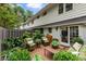 Charming brick patio with green accents, wicker chairs, and an abundance of lush greenery at 136 Peachtree Memorial Nw Dr # Nh4, Atlanta, GA 30309