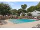 Community pool is surrounded by trees, and lounge chairs at 136 Peachtree Memorial Nw Dr # Nh4, Atlanta, GA 30309