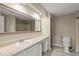 Bright bathroom featuring updated sink, vanity, toilet, and flooring, as well as a large mirror at 1371 Keys Lake Ne Dr, Brookhaven, GA 30319