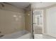 Updated bathroom featuring neutral tile, modern shower head and fixture, and doorway to the bedroom at 1371 Keys Lake Ne Dr, Brookhaven, GA 30319