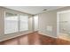 Bright bedroom with two large windows and wood floors leading to the ensuite bathroom at 1371 Keys Lake Ne Dr, Brookhaven, GA 30319