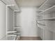 Custom walk-in closet with shelving, hanging rods, baskets, and compartments at 1371 Keys Lake Ne Dr, Brookhaven, GA 30319