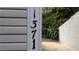 Exterior shot of address numbers against neutral siding and lush greenery at 1371 Keys Lake Ne Dr, Brookhaven, GA 30319