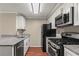 Modern kitchen with granite countertops, stainless steel appliances, and ample cabinet space at 1371 Keys Lake Ne Dr, Brookhaven, GA 30319