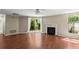 Bright living room with fireplace, wood floors, and sliding glass doors to the backyard at 1371 Keys Lake Ne Dr, Brookhaven, GA 30319