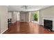 Open living room with fireplace, wood floors, and breakfast bar seating at 1371 Keys Lake Ne Dr, Brookhaven, GA 30319