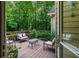 Relaxing back deck area with comfortable seating nestled amongst the trees at 1694 Peachcrest Ct, Lawrenceville, GA 30043