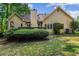 Spacious backyard showcasing the home's exterior and a deck area, framed by lush landscaping at 1694 Peachcrest Ct, Lawrenceville, GA 30043